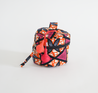 Pink and orange small cosmetic bag. Leather Meron luggage tag.