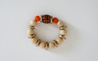 Orange and cream braclet with a floral focus bead