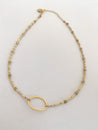 Handmade, minimalist, and short gold beaded necklace with gold-plated oval pendant in center