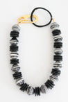Handmade chunky beaded short statement necklace with large paper bead and coconut disc beads with artistic oversized clasp and cattle horn "O" detail