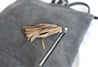 Ethically sourced large suede backpack with sheepskin leather tassel handmade by artisans overcoming poverty in Ethiopia