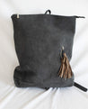 Ethically sourced large suede backpack with sheepskin leather tassel handmade by artisans overcoming poverty in Ethiopia