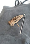 Ethically sourced large suede backpack with sheepskin leather tassel handmade by artisans overcoming poverty in Ethiopia