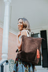 Ethically sourced large suede backpack with sheepskin leather tassel handmade by artisans overcoming poverty in Ethiopia