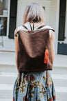 Ethically sourced large suede backpack with sheepskin leather tassel handmade by artisans overcoming poverty in Ethiopia