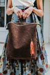 Ethically sourced large suede backpack with sheepskin leather tassel handmade by artisans overcoming poverty in Ethiopia