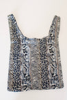 Animal print tote bag with leopard and snakeskin pattern in black, beige, and cream tones.