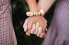wooden bracelets mixed with beads in blush, and colorful beads