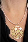 pink and pearl necklace with gold floral charm