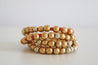 gold, red, and dusted white, necklace that doubles as a bracelet