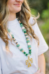 model wearing a jade chunky necklace with a thunder bird pendant