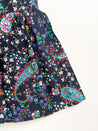 Festive wrap skirt with black background and colorful paisley and floral pattern sewn in the USA