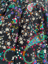 Festive wrap skirt with black background and colorful paisley and floral pattern sewn in the USA