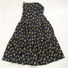 Wrap skirt with black background with neon yellow and purple small repeating floral clusters