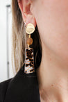 long earring in gold, brown, and marble colors