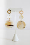 3 circles hanging earrings in warm and earthy tones with gold accents.