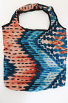 Colorful patterned bag in blue and brown.