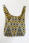 Reusable bag with geometric pattern in yellow, navy, and black.
