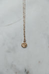 Minimalist gold necklace with a gold-plated cross charm on an 18k gold-filled chain